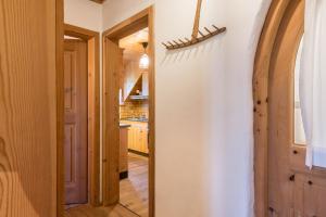 a hallway with a door leading into a kitchen at Ronacherhof Apt Ringelblume in Collalbo +31 photos