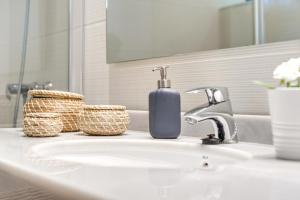 a bathroom sink with a soap dispenser on it at Finca Sa Pradera in Palma De Mallorca +22 photos