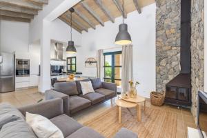 a living room with a couch and a fireplace at Finca Sa Pradera in Palma De Mallorca