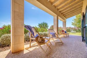 two deck chairs sitting on a porch at Finca Sa Pradera in Palma De Mallorca