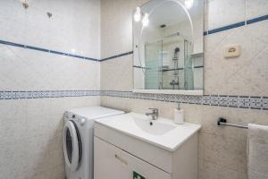 a bathroom with a washing machine and a sink at Isabel apartment in Carvoeiro +20 photos
