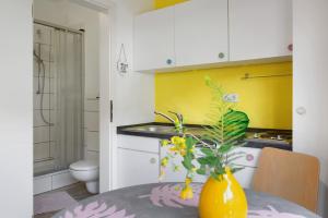 a kitchen with a table and a vase with flowers on it at Studio-in der atelierhaus Loft in Bodman-Ludwigshafen