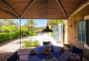 a table with a blue table cloth on a patio at Baix d' Or in Felanitx