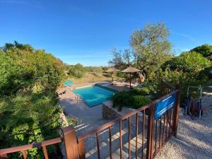 a view of a pool from the balcony of a house at Baix d' Or in Felanitx