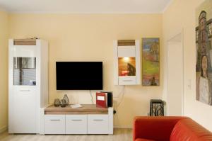 a living room with a tv on a wall at Haus unterm Räuschenberg in Höxter