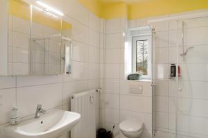 a bathroom with a sink and a toilet and a shower at Haus unterm Räuschenberg in Höxter +26 photos