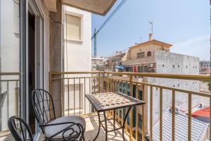 a table and chairs on a balcony with a view at Calle Apolo 3 in Torrevieja