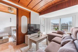a living room with a couch and a tv at Calle Apolo 3 in Torrevieja