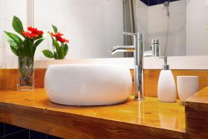 a white sink on a wooden counter in a bathroom at Holidays Maxorata Relax in Gran Tarajal +15 photos