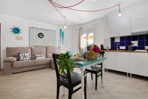 a kitchen and living room with a table and a couch at Holidays Maxorata Relax in Gran Tarajal