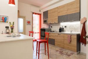 a kitchen with wooden cabinets and a counter top at Art Rooms in Arezzo