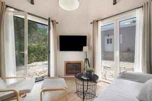 a living room with a bed and a fireplace at Stathis Suite in Exanthia