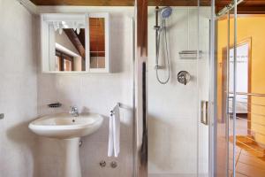 a bathroom with a sink and a shower at Intelvi House in Castiglione dʼIntelvi +23 photos