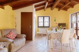 a living room with a couch and a table at Intelvi House in Castiglione dʼIntelvi