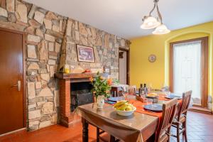 a dining room with a table and a stone wall at Bella Toscana Relax in Monsummano Terme