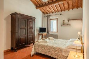 a bedroom with a bed and a television in it at Bella Toscana Relax in Monsummano Terme +27 photos