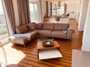a living room with a couch and a table at Moin Mehrblick in Schillig