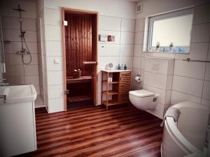 a bathroom with a toilet and a sink at Moin Mehrblick in Schillig +21 photos