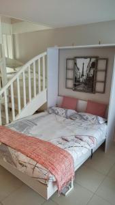 a bed in a room next to a staircase at 135m2 - Villa, 5 min to the park - DISNEY MAGICAL HOMES, PARIS in Magny-le-Hongre