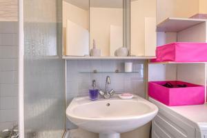 a bathroom with a white sink and pink cabinets at Chambre double à Toulouse in Toulouse +11 photos