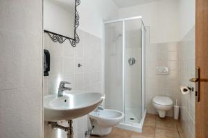 a bathroom with a sink and a shower and a toilet at Appartamenti Ride Home in Commezzadura +40 photos