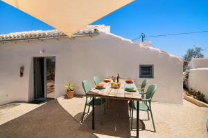 a table and chairs sitting on a patio at Casa Burro in Moncarapacho