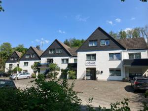 a large white building with cars parked in a parking lot at Kehl Vogt Ferien Apart in Warstein