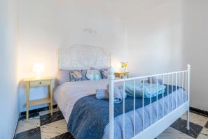 a bedroom with a white bed and two night stands at Fantastic in Can Picafort