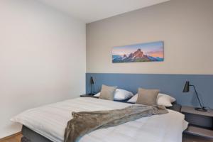 a bedroom with a bed and a painting on the wall at New Opening Vinea Guesthouse in Cornedo all'Isarco