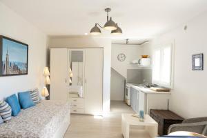 a living room with a bed and a kitchen at Studio Proche Lac Hossegor in Hossegor +13 photos