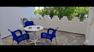 a table and chairs sitting on a patio at Pico Bello Patmos 24 in Patmos
