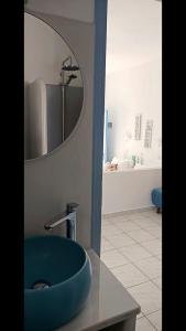 a bathroom with a blue sink and a mirror at Pico Bello Patmos 24 in Patmos +31 photos