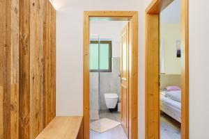 a bathroom with a toilet and a bedroom at Oberhemberger Hof Feldthurns in Feldthurns +63 photos