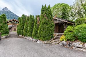 a group of trees in front of a building at Chalet indépendant 3 personnes in Alex
