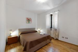 a bedroom with a bed in a white room at La Casa Sul Lago in Osiglia