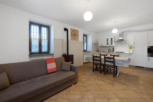 a living room with a couch and a table and a kitchen at La Casa Sul Lago in Osiglia
