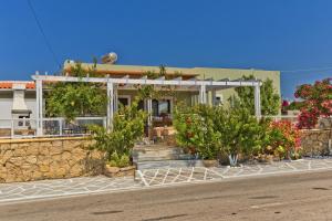 a house with trees and flowers in front of it at Villa Ntora in Afiartis +22 photos