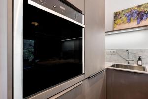 a kitchen with a large oven and a sink at New Opening Vinea Guesthouse in Cornedo all'Isarco +75 photos