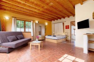 a living room with a couch and a bed at Yukalele 2 in Lajares