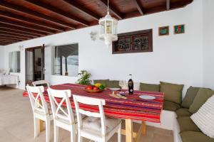 a dining room with a table and a couch at Casa Carmen - Comfort and Privacy in Nazaret