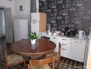 a kitchen with a table and a chalkboard wall at La Vista Sul Castello in Compiano