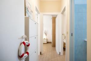 a bathroom with a towel dispenser on the wall at Areon - Central Coastal Residence in Porto Cesareo +21 photos