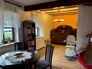 a living room with a dining room table and chairs at Ferienhaus Waldeck in Marienberg