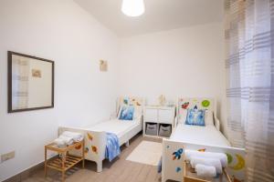 a room with two beds and a mirror at Areon - Central Coastal Residence in Porto Cesareo