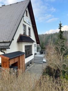 a building with a deck and stairs in front of it at Ferienhaus Waldeck in Marienberg