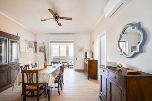 a kitchen and dining room with a table and chairs at Areon - Central Coastal Residence in Porto Cesareo