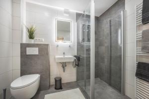 a bathroom with a toilet and a sink and a shower at Ferienhaus Inge in Oldenburg +17 photos