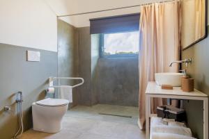 a bathroom with a toilet and a sink and a shower at Casale Lorenzo Appartamenti in Orbetello +107 photos