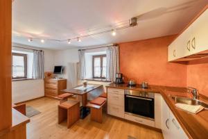 a kitchen with a table and a counter top at Florerhof Ferienwohnung Rose in Vols am Schlern