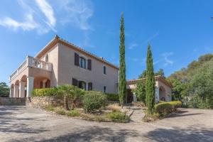 a large house with trees in front of it at Villa Elisabeth in Fréjus